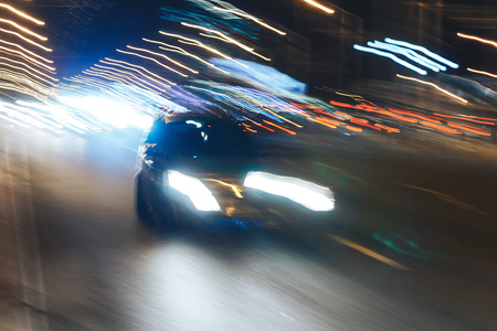 The car is driving along the road. Long exposure. Blurred backgroundの写真素材
