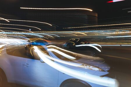 The car is driving along the road. Long exposure. Blurred backgroundの写真素材