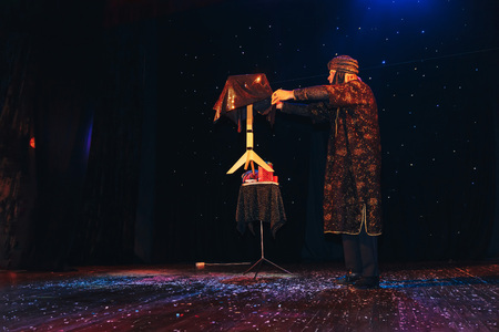MINSK, BELARUS November 4 2017 International Illusion Festival MAGIC 2017 Male magician shows a performance with a raised tableのeditorial素材