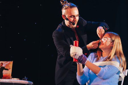 MINSK, BELARUS November 4 2017 International Illusion Festival MAGIC 2017 A young magician takes an assistant girlのeditorial素材