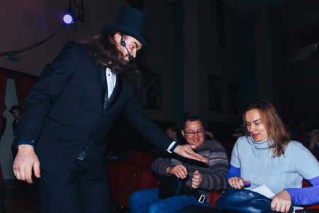 MINSK, BELARUS November 4 2017 International Illusion Festival MAGIC 2017 Male magician asks the girl to be an asylumのeditorial素材