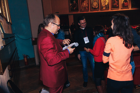 MINSK, BELARUS November 4 2017 International Illusion Festival MAGIC 2017 A man in a red suit with a microphone talking to a group of people in the audienceのeditorial素材