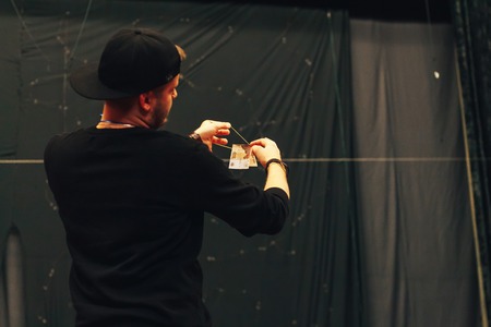 MINSK, BELARUS November 4 2017 International Illusion Festival MAGIC 2017 Seminar The guy shows how to do tricks with an elastic band and moneyのeditorial素材