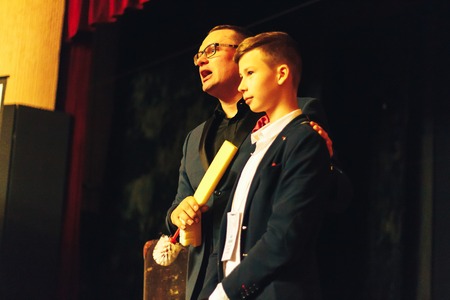 MINSK, BELARUS November 5 2017 International Illusion Festival MAGIC 2017 Seminar A young magician with an assistant shows the performance on stageのeditorial素材