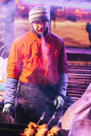 Minsk, Belarus, December 24, 2017 The man is preparing a shish kebabのeditorial素材