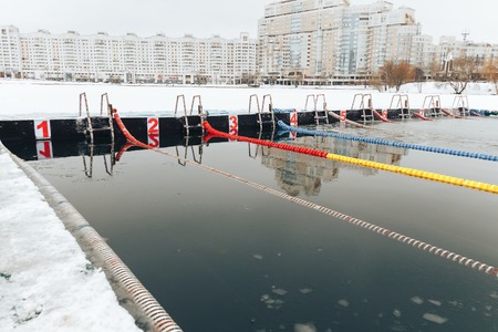Swimming pool for winter is cut from the ice in the riverの写真素材
