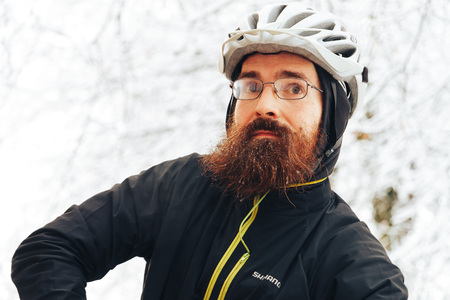 Minsk, Belarus, December 10, 2017 Volunteer's Day A man with a beard and a bicycle helmet is standing outdoorsのeditorial素材
