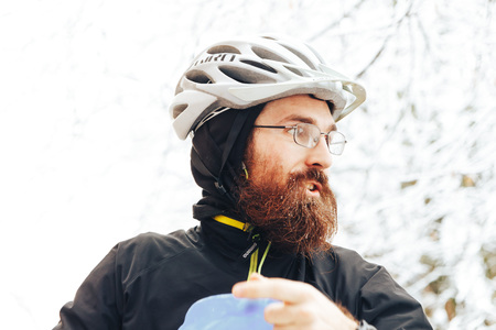 Minsk, Belarus, December 10, 2017 Volunteer's Day A man with a beard and a bicycle helmet is standing outdoorsのeditorial素材