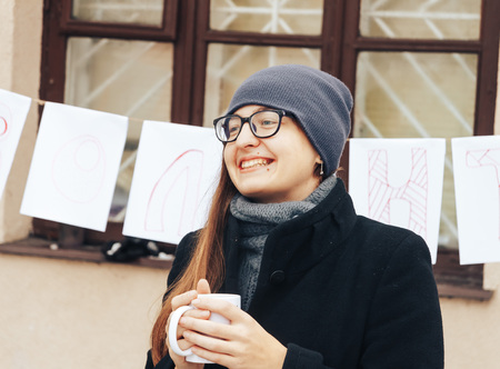 Minsk, Belarus, December 10, 2017 Volunteer's Day Girl stands outdoors with a cupのeditorial素材