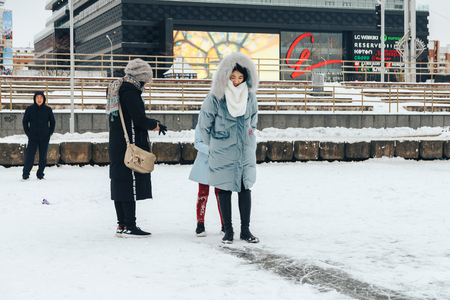 Minsk Belarus January 21, 2018 A little girl with her mom's ride on iceのeditorial素材