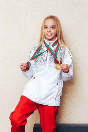 Minsk Belarus February 4, 2018 The girl shows medals for rhythmic gymnastics competitionsのeditorial素材