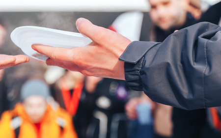 Homeless man holding a bowl of foodの写真素材