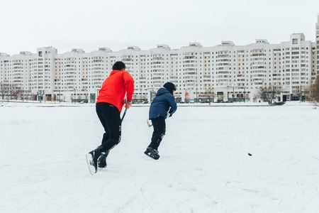 Minsk Belarus January 21, 2018 Walking on the ice of a frozen river Boy and boy playing hockeyのeditorial素材