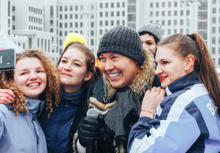Minsk, Belarus. March 8, 2018 Women's Race Public action Women against violence A man with a microphone and a group of girls doing a salfiのeditorial素材