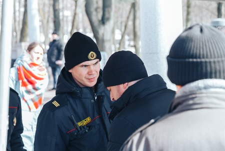 Minsk, Belarus. March 25, 2018 A holiday dedicated to the 100th anniversary of the founding of the Belarusian People's Republic Men stand in front of policemenのeditorial素材