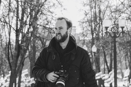 Minsk, Belarus. March 25, 2018 A holiday dedicated to the 100th anniversary of the founding of the Belarusian People's Republic A man with a camera is standing outdoorsのeditorial素材
