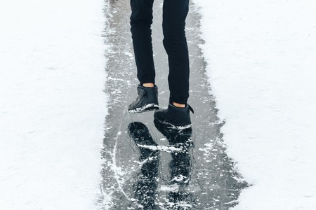 A guy is riding on the ice of a frozen river