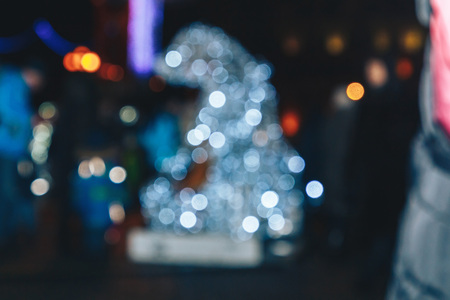 Blurred background of colorful lights of a luminous figure of a hare. An image of an abstract blurred bokeh background with warm colored lightsの写真素材