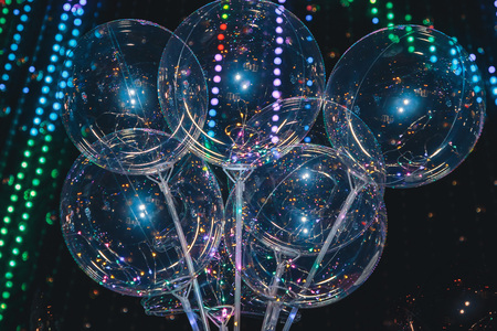 Balloons on the background of blurry lights. An image of an abstract blurred bokeh background with warm colored lightsの写真素材
