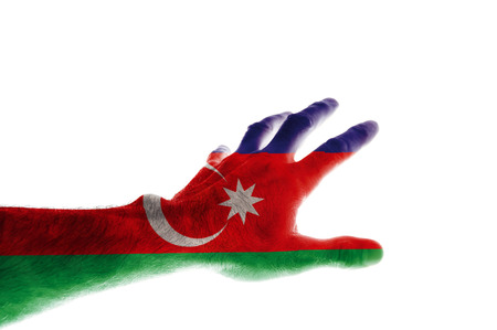 The hand of a mature man painted in the colors of the Azerbaijani flag stretches forward with fingers spread Abstraction dedicated to the Independence Day of Azerbaijan on May 28 Isolated on white.の写真素材