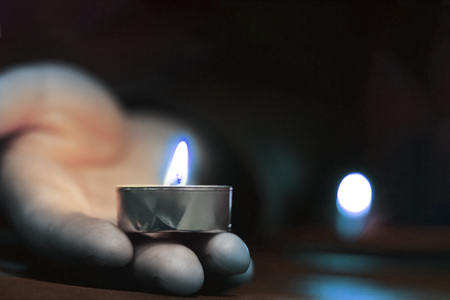 Memorial Day International Holocaust Remembrance Day On the day of the memory of the dead a hand holds a candle Close upの写真素材
