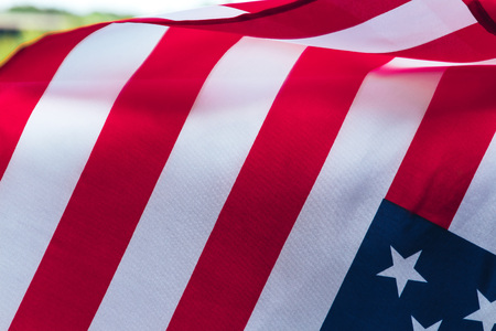 Us flag hanging in front of the forestの写真素材