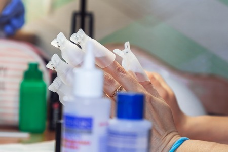 Female hand is in manicure covers. Development of private business in the field of beauty and health Close upの写真素材