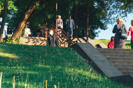 May 25, 2019 Minsk Belarus Street festivities in the evening city Concrete staircase in a park next to trees and green grassのeditorial素材