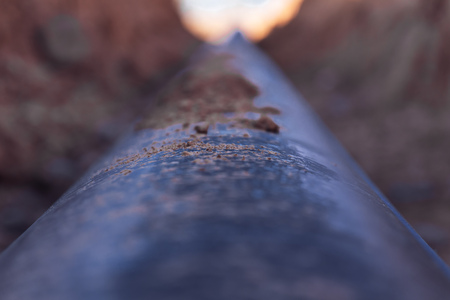 Plastic water pipe is in the trench in the direction under a blue sky residential buildings Close up