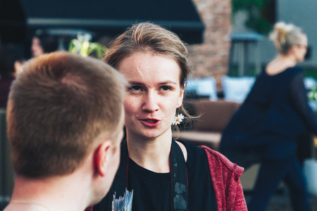 May 25, 2019 Minsk Belarus Street festivities in the evening city A girl tells a story to a young man.のeditorial素材