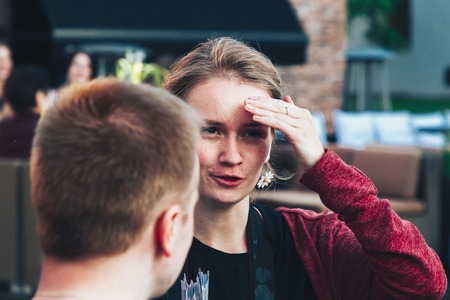 May 25, 2019 Minsk Belarus Street festivities in the evening city A girl tells a story to a young man.のeditorial素材