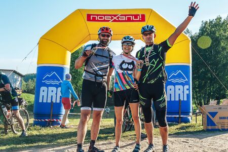 May 26-27, 2018 Naliboki,Belarus All-Belarusian amateur marathon Naliboki Happy two men and a woman stand with medalsのeditorial素材