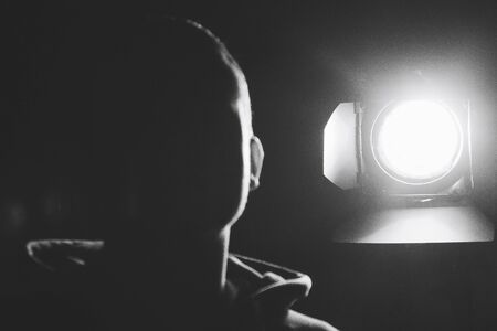 The guy standing next to a luminous spotlight on the street Black and white imageの写真素材