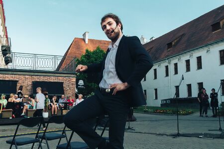 May 25, 2019 Minsk Belarus Street festivities in the evening city A man shows a theatrical performance on the street Close upのeditorial素材