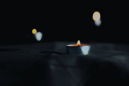 A symbol of remembrance of the victims of the genocide of the Jew Candles burning over the Star of David on a black background in the day of sorrow.の写真素材