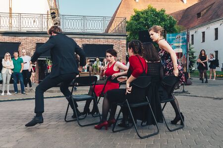 May 25, 2019 Minsk Belarus Street festivities in the evening city A man and four women show a performance on the street.のeditorial素材