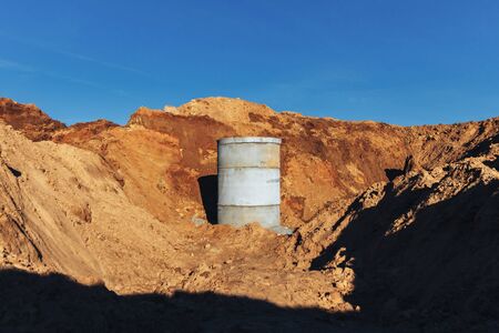 Concrete well for sewage and water supply against the blue sky