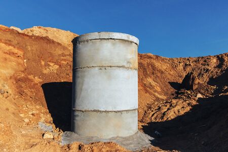 Concrete well for sewage and drainage against the blue skyの写真素材