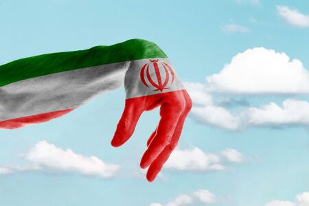 Hand painted in the colors of the flag of Iran against the blue skyの写真素材