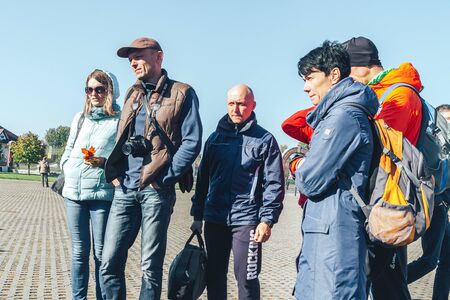 October 6, 2018 Novogrudok Belarus Castle Road People stand on the square against the blue sky. A...