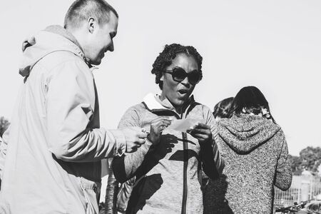 October 6, 2018 Novogrudok Belarus Castle Road A woman asks how to fill a document with a man Black and white imageのeditorial素材