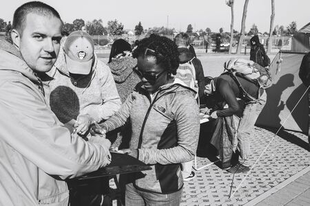 October 6, 2018 Novogrudok Belarus Castle Road A woman fills out an application for participation in...