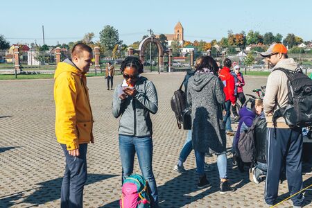 October 6, 2018 Novogrudok Belarus Castle Road People stand on the square before the race.のeditorial素材