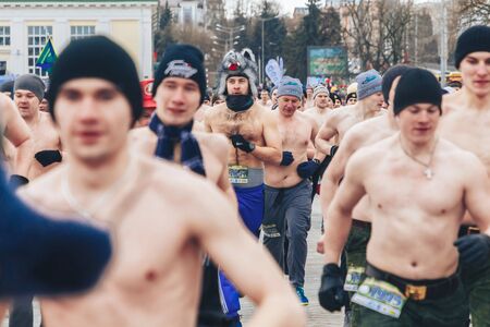 February 23, 2019 Minsk Belarus The race in honor of the holiday on February 23 Men with a naked torso running down the city streetのeditorial素材