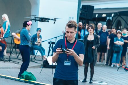 May 25, 2019 Minsk Belarus Street festivities in the evening city A young man leads a quadcopter to...