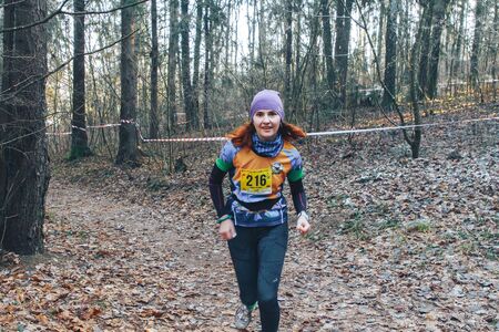 November 17, 2018 Logoisk Belarus Beetle-trail 8 LOGOISK Girl athlete runs in the forest in autumn....