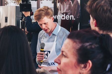 June 1, 2019 Minsk Belarus Public demonstration of cooking on the street A chef with a microphone recognizes the audience's impressions at a master class. A big camera shoots it.のeditorial素材