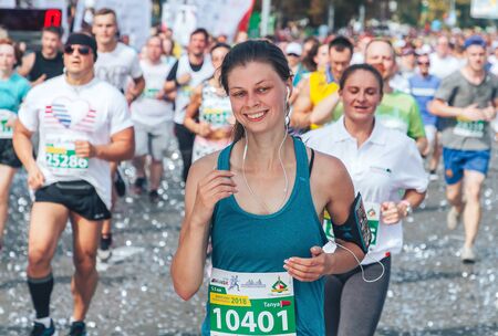 September 9, 2018 Minsk Belarus Half Marathon Minsk 2018 Happy woman in headphones running a...