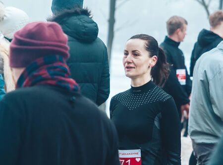 February 9, 2019 Minsk Belarus Run dedicated to February 14 Woman runner stands among the people in...