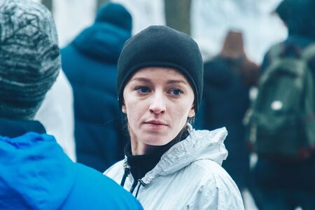 February 9, 2019 Minsk Belarus Run dedicated to February 14 Woman stands thinking among people in the parkのeditorial素材
